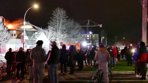 Massive crowd looking mansion fire Stock Footage 139657246