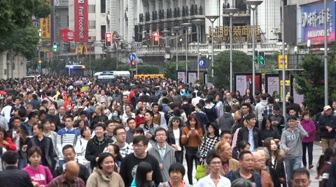 Massive crowds walk through popular shopping street in Shanghai, China 動画素材 67545877