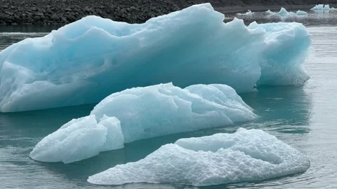 Massive crystal-blue icebergs drift across Jökulsárlón Glacier Lagoon, Iceland Stock Footage 312232830