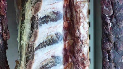 Massive cut of meat hanging at a downward angle Stock Footage 294169324