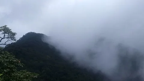 Massive Dark Rain Clouds Move Into The Shot From The Left Above The Hill Stock Footage 162659874