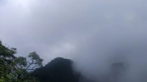Massive Dark Rain Clouds Move Into The Shot From The Left Above The Hill Stock Footage 162659875