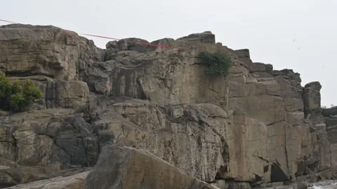Massive Dark Rocky Cliff Under Overcast Sky. Stock Footage 338320016