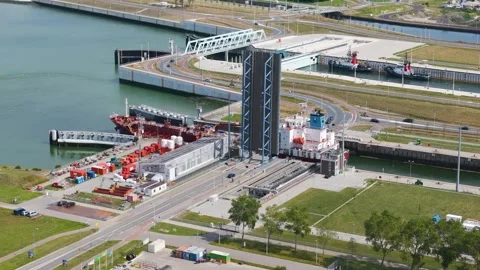 Massive drawbridge stands vertically allow large cargo ship pass vessel moves Stock Footage 327649341
