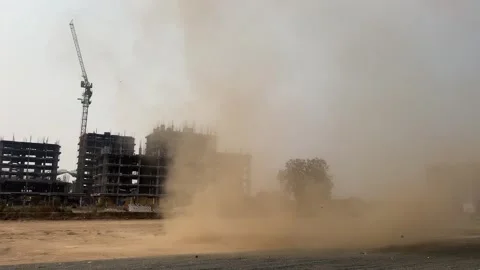 Massive Dust Cloud Swirling on a Large Construction Site with Under Development Stock Footage 336797823