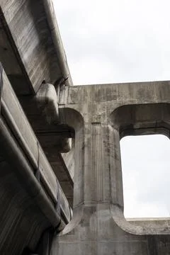 A massive electric train structure is supported by a concrete column framewor Stock Photos
