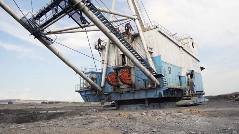 A Massive Excavator Operating at a Mining Site for Resource Extraction and Stock Footage 281561474