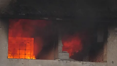 Massive fire burning house after missile attack explosion in Israel–Hamas Stock Footage 275837437