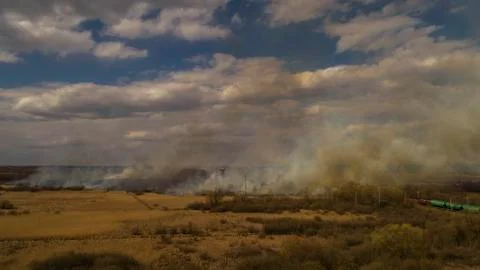 Massive Fire, Dry Grass Lanes in Fire, Firefighters at Work Stock Photos