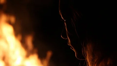 The massive fire lights up the kid's face Stock Footage 122355692