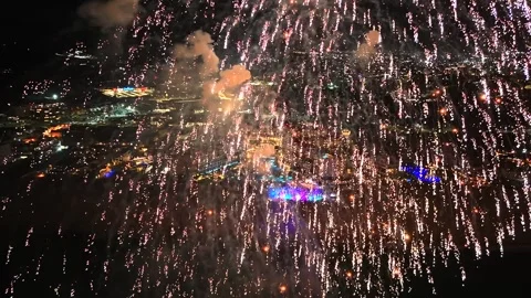 Massive Firework Explosion Above Live Beach Concert and City Lights Video stock 334010997