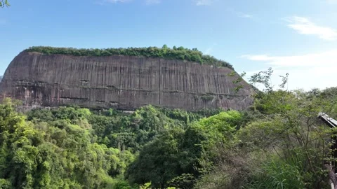 Massive flat top mountain with vertical rock textures rising Stock Footage 339266486