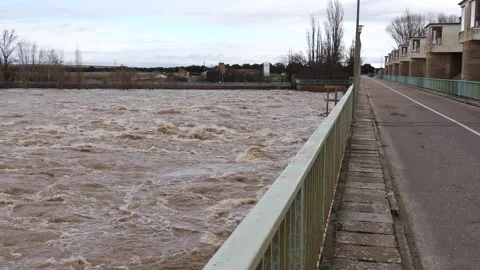 Massive Floodwaters Rushing Beneath Bridge After Excessive Rainfall Stock Footage 329110307