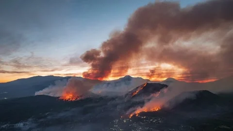 Massive forest fire spreading across the mountain range Stock Footage 338372636