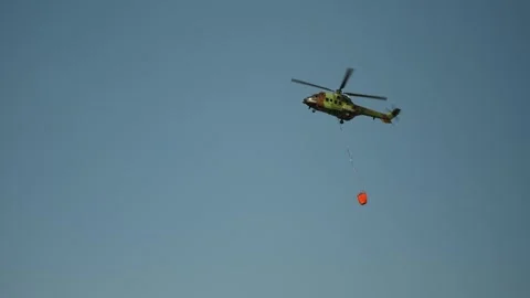 Massive forest fires sparked by global warming fought by aerial helicopter Stock Footage 343060098