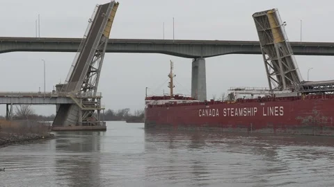 Massive freighter cargo ship sailing up the Welland canal Stock Footage 152072877