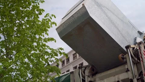Massive garbage can collection truck emptying and processing trash Stock Footage 280770694
