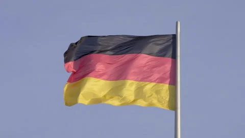 Massive German flag flies in slow motion in strong breeze Stock Footage 135636676
