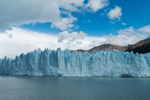 Massive glacial wall and floating ice formations in Patagonian waters Stock Photos