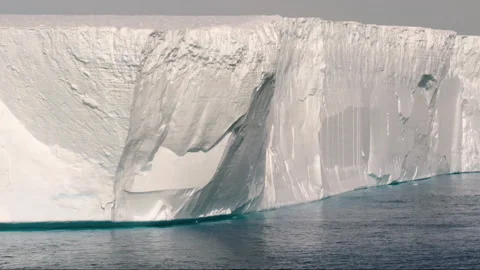 Massive glacier calving into the antarctic ocean Stock-Footage 334986543
