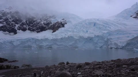 Massive Glacier Flowing into the Ocean on the Antarctic Coast Stock Footage 339651517