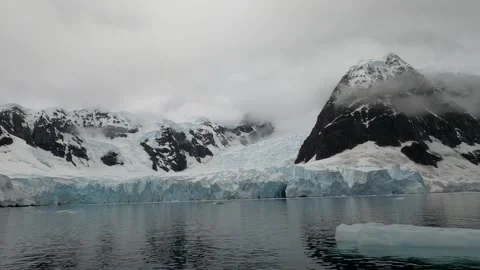 Massive glaciers and snow-covered rugged mountains in Antarctica Stock-Footage 335291102
