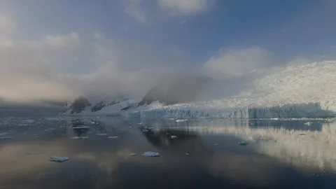 Massive glaciers reflected in calm waters of Southern Ocean in Antarctica Видео 335291614