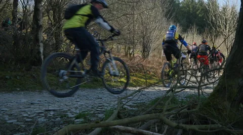 Massive group of mountain bikers begin a climb from trail centre Stock Footage