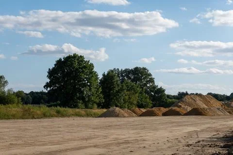 Massive heaps of sand collected across a construction site Фото