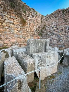 Massive Hewn Blocks Stack Beside Terracotta Walls Under Azure Sky Stock Photos