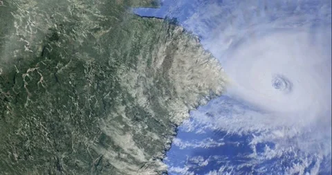Massive hurricane swirls over ocean near lush green coastline viewed from s.. Stock Footage 337481702