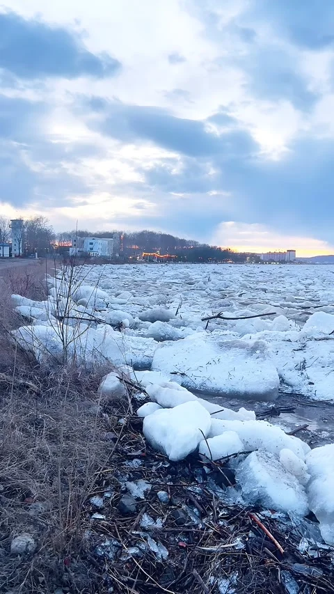 Massive Ice Floes Drifting Along Yellow River Banks with City in Twilight, Jinan 스톡 동영상 336933081