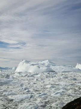 Massive Iceberg Surrounded by Dense Floating Ice in Polar Waters, Ilulissat Stock Photos