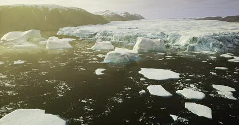 Massive icebergs floating in the Arctic waters during sunset hours Stock Illustration