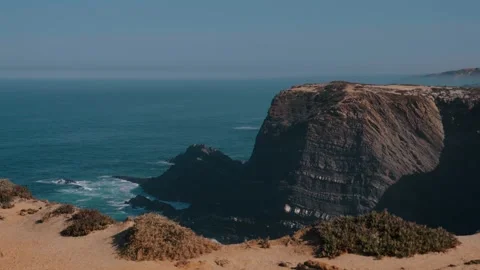 Massive layered sea cliff headland on the Alentejo coast, Portugal Stock Footage 346479937