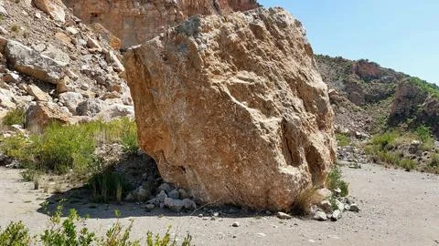 Massive Limestone Boulder in Rugged Arid Canyon Landscape Geological Scene Stock Photos