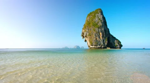 Massive Limestone Rock Formations Towering over Tropical Beach Stock Footage 51195195