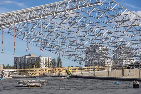A massive metal truss frame structure hangs over the Meritie road construct.. Stock Photos