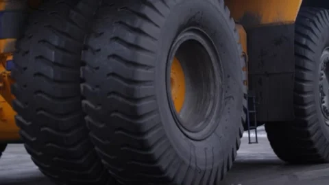 Massive mining truck with huge wheels and suspension drives outdoors. Stock Footage 313815356