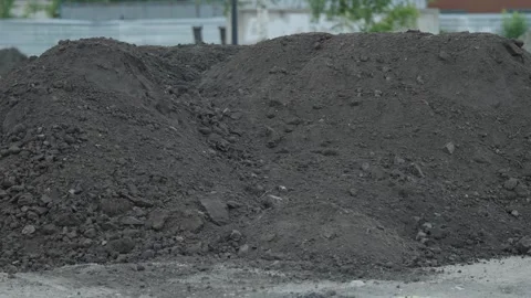 Massive mounds of dark soil and gravel at construction area Stock Footage 337123283