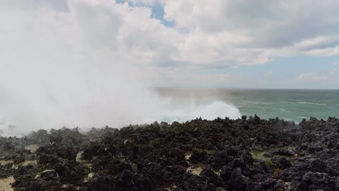 Massive Ocean Wave Exploding Across Jagged Coastal Rocks in Dramatic Slow Motion Stock Footage 337029226