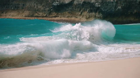 Massive ocean wave rolling onto tropical beach Stock Footage 303394585