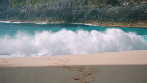 Massive ocean wave rolling onto tropical beach Stock Footage 303396651