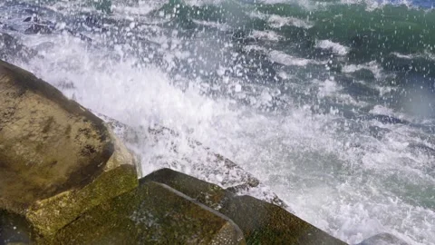 Massive Ocean Waves Crashing Against a Rocky Coastline with Powerful Force Video stock 341872733
