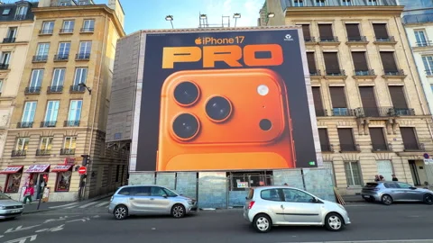 Massive orange iPhone 17 Pro commercial billboard advertisement in Paris, France 動画素材 336721928