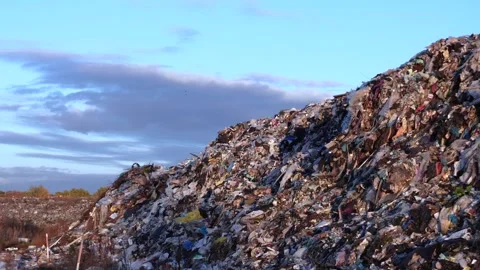 A massive outdoor pile of diverse refuse and discarded materials forms a la.. Stock Footage 321918160