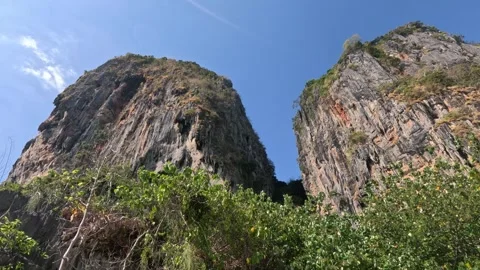 Massive Overhanging Cliffs and Lush Nature on Kolipe Island in Bright Sunlight Video stock 339903687