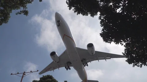 Massive plane flying low about to land in slow motion 120fps Stock Footage 89162434