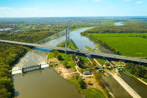 Massive pylon bridge spanning Oder river flowing by Wroclaw Stock Photos
