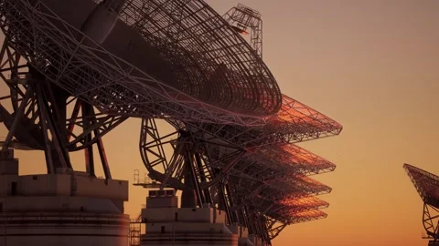 Massive Radio Telescope Array Silhouette Against Golden Hour Sunset Sky Video stock 339071148